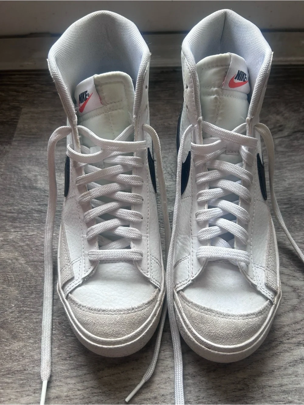 Nike White High-Top Sneakers with Black Swoosh and Pink Tongue Logo